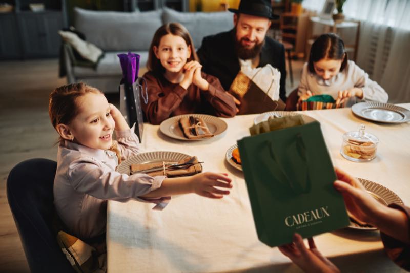 Cadeaux campaign photograph of a family at a table